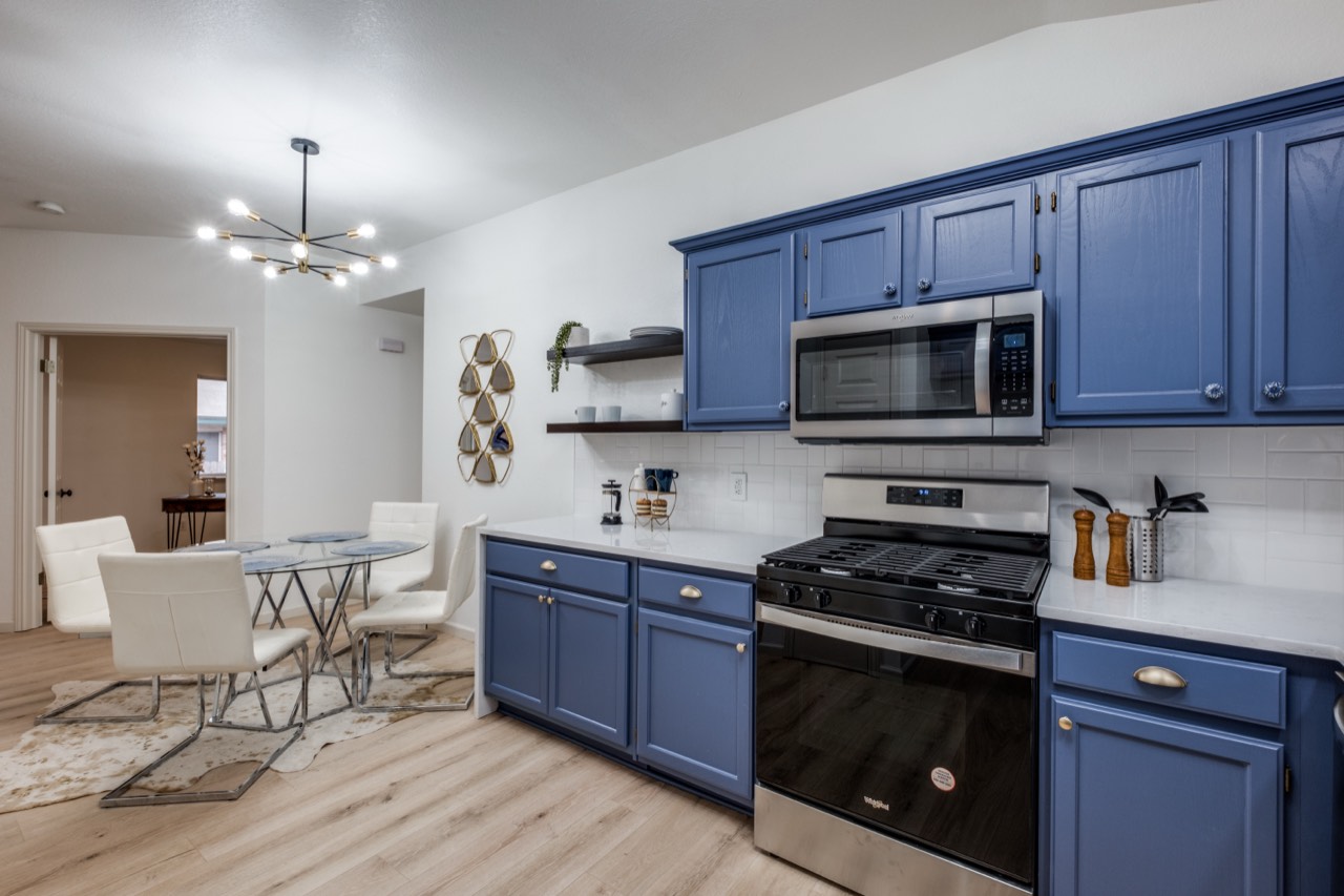 Remodeled kitchen with navy cabinets and brass hardware, Cedar Park TX